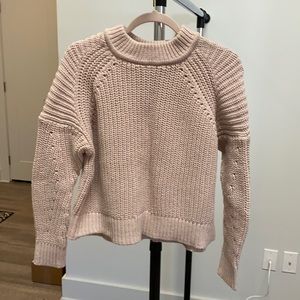 Pale pink sweater.